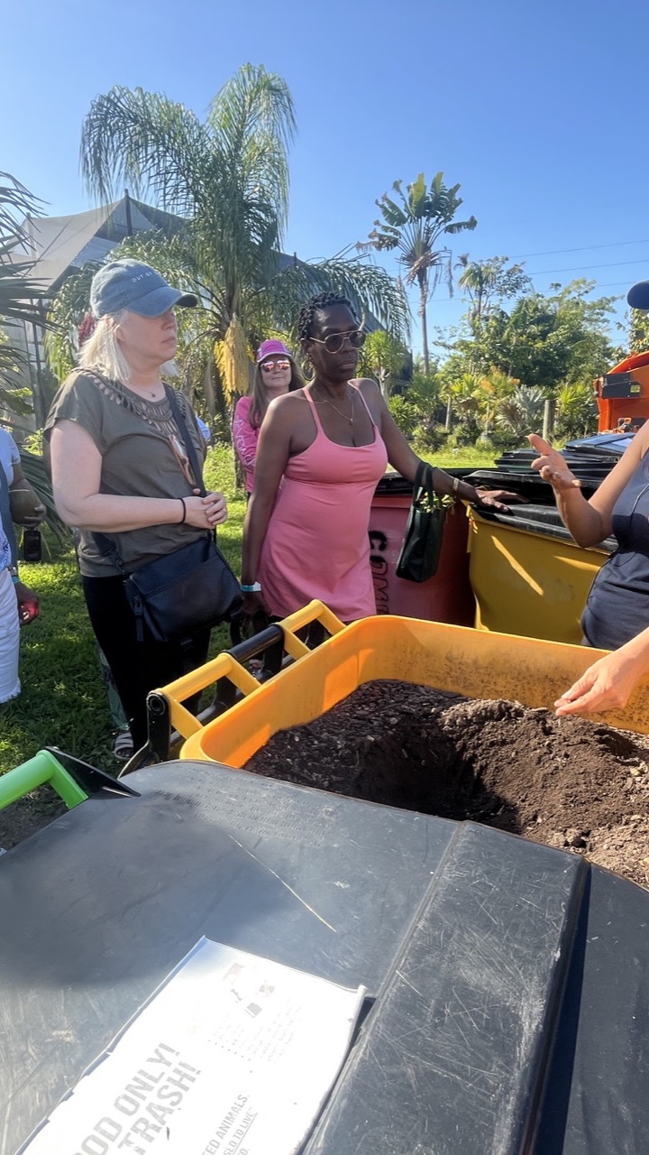 Woman showing a tub of finished compost soil